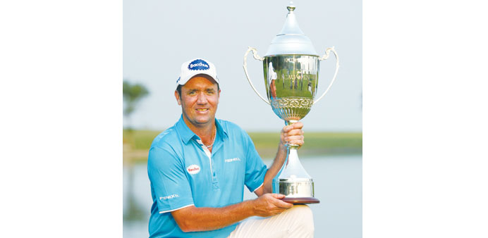 Scott Hend of Australia poses with the winners trophy after the final round of the Macau Open golf tournament yesterday. (AFP)
