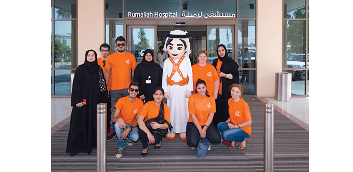 The team from the organising committee at Rumailah Hospital along with the mascot of the games.