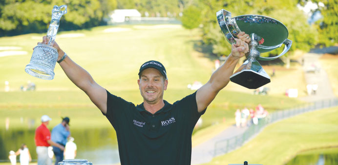 Henrik Stenson displays his winning trophy and silver cup after the final round of the PGA Tour Championship at East Lake Golf Club in Atlanta on Sund