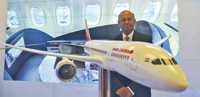 Dinesh Keskar, Boeingu2019s vice-president for sales in Asia Pacific and India, poses with a model of 787 Dreamliner during the Aero India 2013.