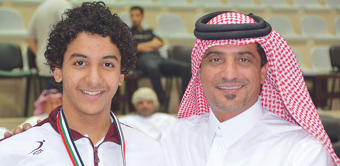 QSA president Khalil al-Jaber with Qatar swimmer Omar Hisham.