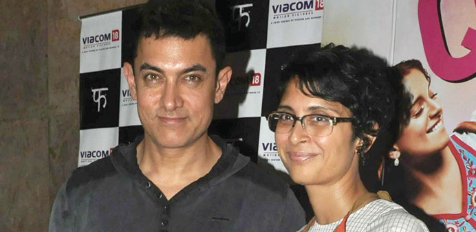 Bollywood actor Aamir Khan and his wife, director Kiron Rao, arrive for a screening of the film Queen in Mumbai on Saturday.