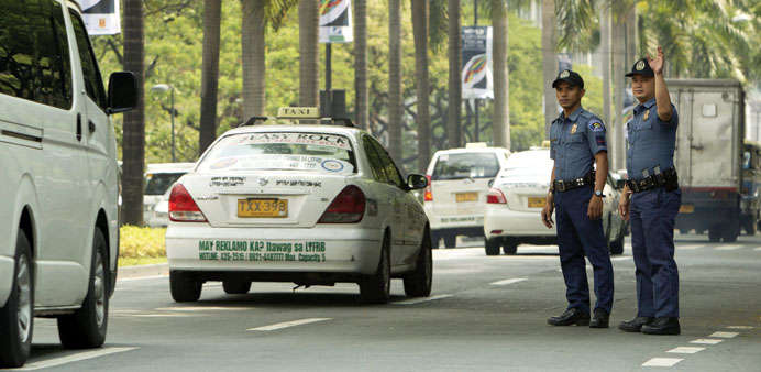 Police officers direct the traffic at the venue of the World Economic Forum in Makati City recently. Deloitte Global has urged the government to reduc