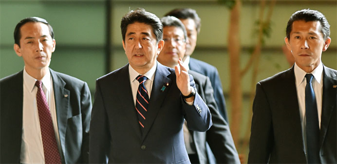 Japanese Prime Minister Shinzo Abe (C) 