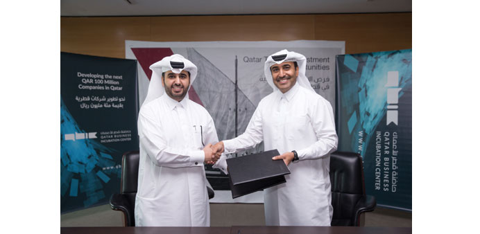Al-Mohannadi (right) and al-Khalifa shake hands after reaching the deal to establish the countryu2019s first Corporate Tourism Incubation Zone at QBIC.