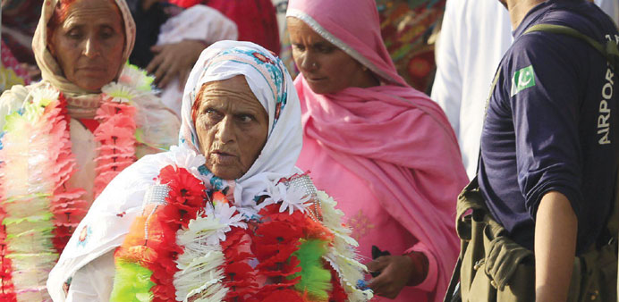 Women returning from the Haj pilgrimage arrive at the Benazir International airport in Islamabad.