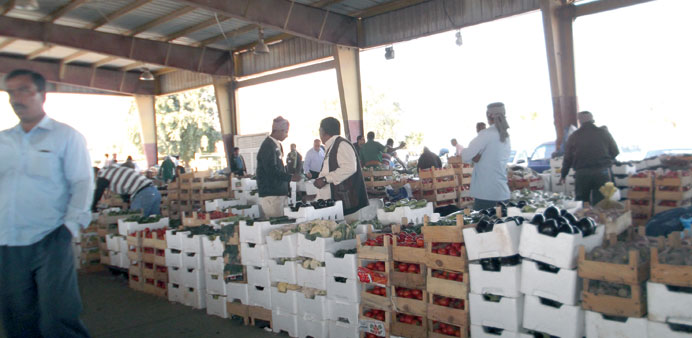  Vendors ply their trade under a shade at the vegetable market in Abu Hamur.