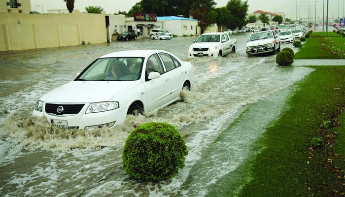Vehicles moving through a flooded street at Nuaija West. PICTURE: Vinod Divakaran