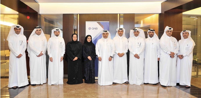 The honoured employees with QNB officials.