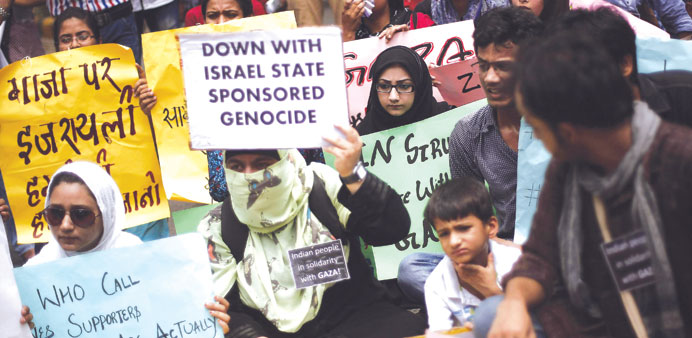 Demonstrators hold placards at a protest rally against the Israelu2019s attacks on Gaza outside the Israeli embassy in New Delhi.