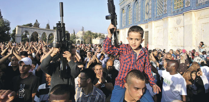 Children hold toy guns during the protest in Jerusalem yesterday. 