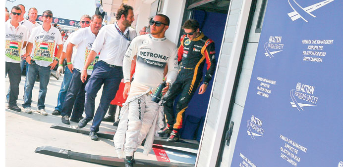 Mercedes driver Lewis Hamilton celebrates taking the pole for the Hungarian Grand Prix yesterday. (EPA)