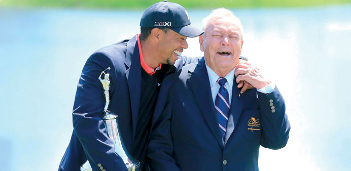 Tiger Woods shares a joke with Arnold Palmer after winning the Arnold Palmer Invitational in Orlando and reclaiming the World No.1 ranking yesterday.