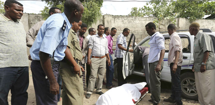 The body of Saado Ali Warsame lies next to her vehicle in Mogadishu.