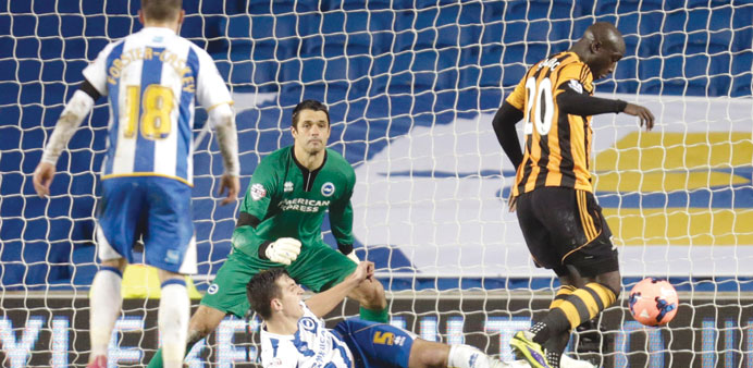 Hull Cityu2019s Yannick Sagbo (right) shoots and scores during their English FA Cup match against Brighton Hove Albion at the Falmer Stadium in Brighton o