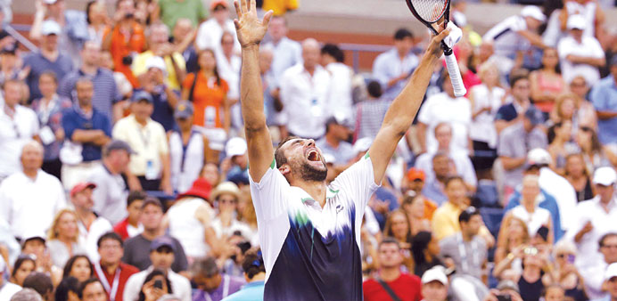 Marin Cilic of Croatia celebrates after defeating Roger Federer of Switzerland in their semi-final match at the US Open on Saturday.