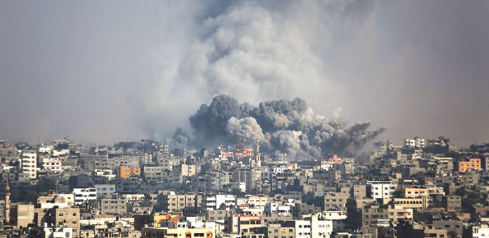 Smoke rises after an Israeli air strike in the Shejaiya neighbourhood of eastern Gaza City yesterday.