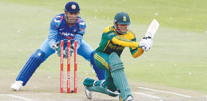 South Africa opener Quinton de Kock sweeps one to the fence en route to his second straight hundred, as Indian captain MS Dhoni (left) looks on, in th