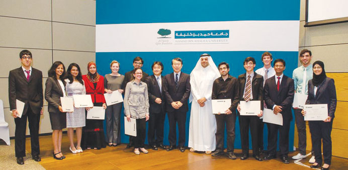 HBKU and Itochu officials with students at the event.