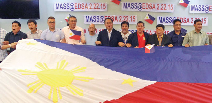 Members of a group called 2/22 Coalition, which seeks the ouster of President Benigno Aquino, hold a giant Philippine flag.