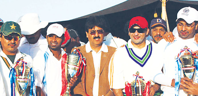 Good JOB: Captains of the Division B and Division C finalists pose with QCA Head of Domestic Cricket Gul Khan with their trophies.