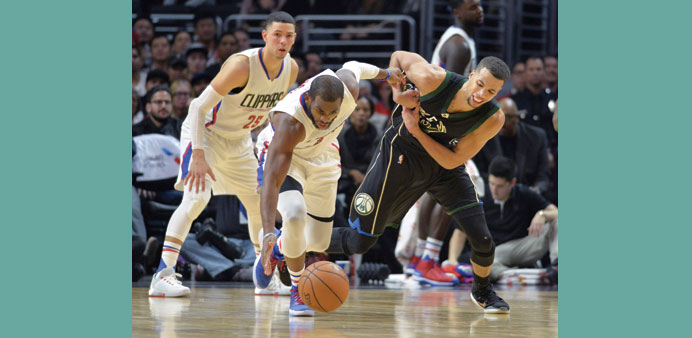 Los Angeles Clippers guard Chris Paul (centre) battles for the ball.