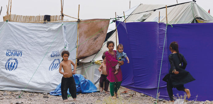 Displaced Pakistani children play outside their tent at a refugee camp in Khost province.