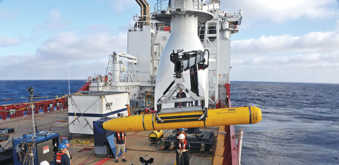 Operators aboard the Australian Defence Vessel Ocean Shield move the US Navyu2019s Bluefin-21 autonomous underwater vehicle into position for deployment i