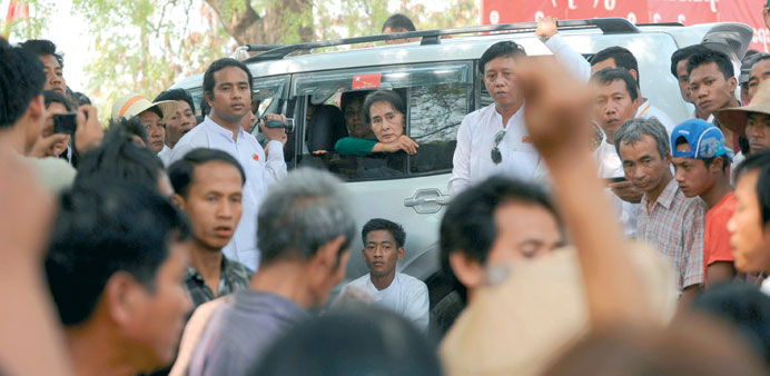 Myanmar opposition leader Aung San Suu Kyi watches from her car as people protest against the Chinese-backed copper mine project, in Monywa yesterday.
