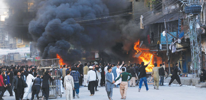   Shops at a market set on fire following clashes in Rawalpindi yesterday.