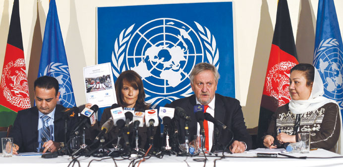 Director of Human Rights for the UN Assistance Mission in Afghanistan Georgette Gagnon (second left) holds up a copy of a report of civilian casualtie