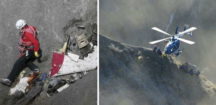 A French rescue worker inspects the remains of the Germanwings Airbus A320 at the site of the crash. Right: A French Gendarmerie rescue helicopter dro