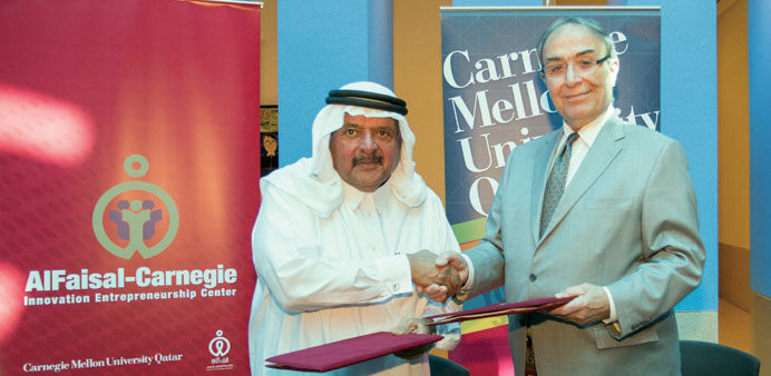 HE Sheikh Faisal and dean Baybars shake hands after signing the agreement.