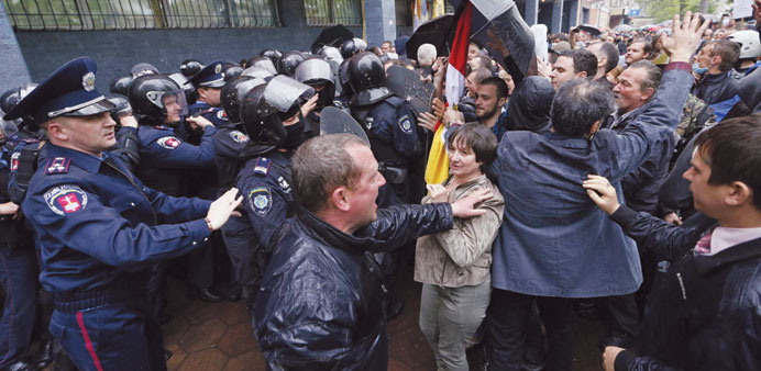 Protesters surround Ukrainian Interior Ministry security forces who formed a cordon outside a city police department in the Black Sea port of Odessa y