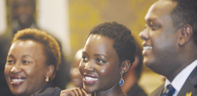Oscar winning Kenyan actress Lupita Nyongu2019o (centre) smiles during a press conference in Nairobi yesterday.