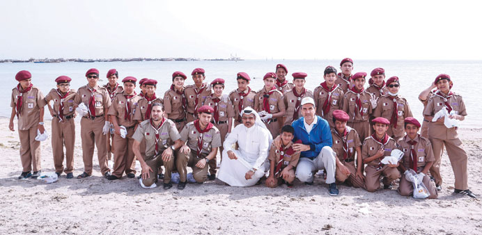 Dr al-Mulla and another official are seen with a group of volunteers who participated in the clean-up campaign.