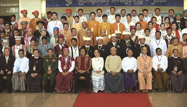 Myanmar State Counsellor Aung San Suu Kyi with President Htin Kyaw, UN Secretary General Ban Ki-Moon (left) and Myanmar military chief Senior General Min Aung Hlaing (fourth left) pose for a group picture with ethnic rebel leaders and top government officials during the opening of the peace conference in Naypyidaw yesterday.