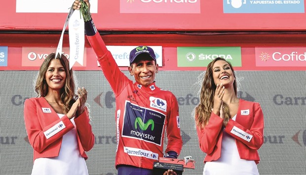 Movistaru2019s Colombian cyclist Nairo Quintana celebrates on the podium retaining the red jersey after 20th stage of the 71st edition of u2018La Vueltau2019 Tour of Spain, a 184km route Benidorm to Alto de Aitana, yesterday. (AFP)