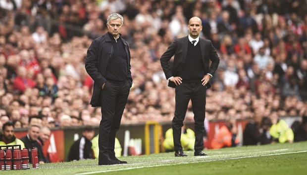 Manchester Unitedu2019s Portuguese manager Jose Mourinho (L) and Manchester Cityu2019s Spanish manager Pep Guardiola (R) watch from the touchline during the EPL clash between the two teams at Old Trafford in Manchester yesterday.