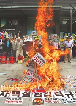 Activists set fire to an effigy of North Korean leader Kim Jong-un during a protest in Seoul yesterday.