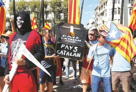 Participants march with a mock-up of a coffin bearing the lettering u2018Catalan countryu2019 during a demonstration in Perpignan of the citizen movement u2018Oui au Pays Catalanu2019 (Yes to the Catalan Country) against the name u2018Occitanieu2019 as a reference to the region.