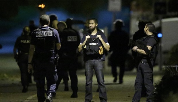 French policemen take part in a police raid