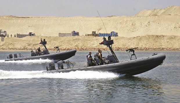 Security personnel cross through the New Suez Canal, Ismailia, Egypt (file). The military essentially oversaw the construction of the Suez Canal expansion and has been pushing into key areas such as food.