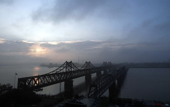 The sun rises over the China-North Korea Friendship Bridge.