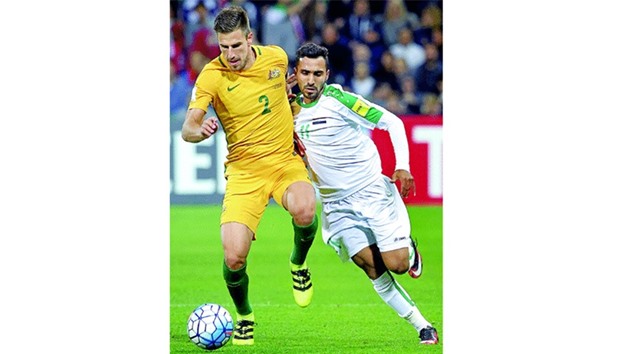 Milos Degenek of Australia competes for the ball with Ali Husni Faisal of Iraq.