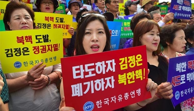 South Koreans hold placards reading ,Down with Kim Jong-Un, Eliminate North Korean nuclear!, during a protest denouncing North Korea's latest nuclear test, in Seoul on Monday.