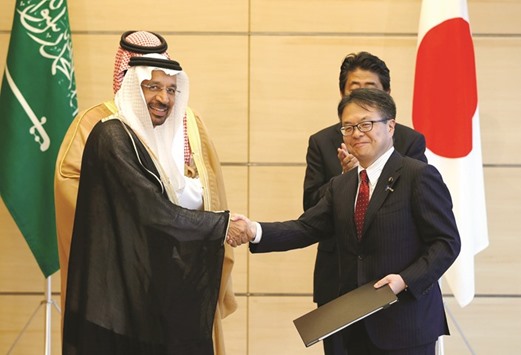 Saudi Energy Minister Khalid al-Falih (left) shakes hands with Japanu2019s Trade and Industry Minister Hiroshige Seko as Saudi Deputy Crown Prince Mohammed bin Salman (behind al-Falih) and Prime Minister Shinzo Abe (behind Seko) look on, during a ceremony exchanging documents on both countriesu2019 diplomatic agreements at Abeu2019s  official residence in Tokyo yesterday. The worldu2019s biggest exporter plans to increase the amount of storage capacity it uses on Japanu2019s Okinawa islands, where itu2019s been  leasing tanks since 2010, Amin Nasser chief executive officer of Saudi Arabian Oil Co, said yesterday in Tokyo.