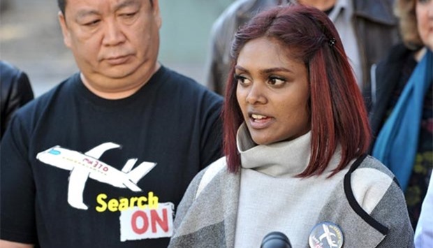 Grace Nathan, a relative of one of the victims from Malaysia Airlines flight MH370 which disappeared in 2014, stands with Bai Shuanfu (left), another relative of the missing, as she speaks to the media after a meeting with the Australian Transport and Safety Bureau and the Joint Agency Coordination Centre in Canberra on Monday.