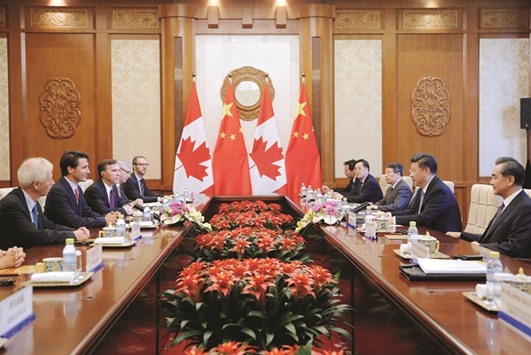 Chinese President Xi Jinping (2nd from right) and Canadian Prime Minister Justin Trudeau (2nd from left) hold their meeting at the Diaoyutai State Guesthouse in Beijing. China is Canadau2019s top export market for the oilseed, and Ottawa has taken a strong line in talks on a new standard, which may raise costs for exporters.