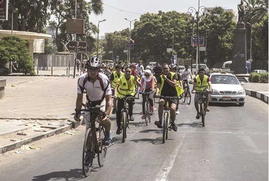Egyptians ride their bicycles in the capital Cairo on August 19. Sport in Egypt used to be mainly practised in clubs reserved for the elite. But now, joggers and cyclists of all backgrounds are using social medias to organise group outings across the city.